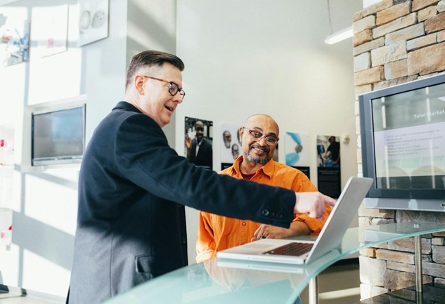 A salesperson works to finish a deal with a customer at the bottom of the funnel